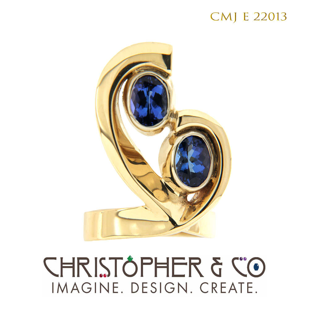 CMJ E 22013  Yellow and white gold ring designed by Christopher M. Jupp set with a tanzanite pair. by Christopher M. Jupp  Image: CMJ E 22013  Yellow and white gold ring designed by Christopher M. Jupp set with a tanzanite pair.