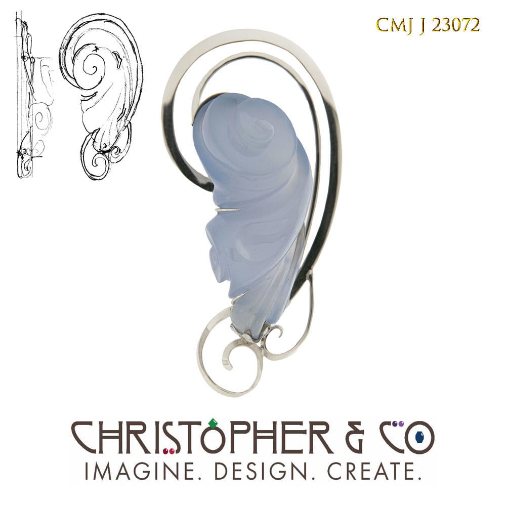 CMJ J 23072 White gold pendant designed by Christopher M. Jupp.  The pendant is set with a blue chalcedony hand-carved by Darryl Alexander. by Christopher M. Jupp  Image: CMJ J 23072 White gold pendant designed by Christopher M. Jupp.  The pendant is set with a blue chalcedony hand-carved by Darryl Alexander.