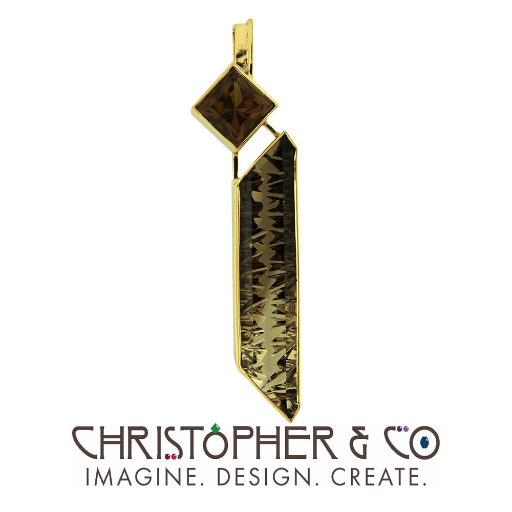 CMJ N 21116 Gold pendant designed by Christopher M. Jupp set with cognac citrine and smokey quartz handcut by Brian Messing.  Image: CMJ N 21116 Gold pendant designed by Christopher M. Jupp set with cognac citrine and smokey quartz handcut by Brian Messing.