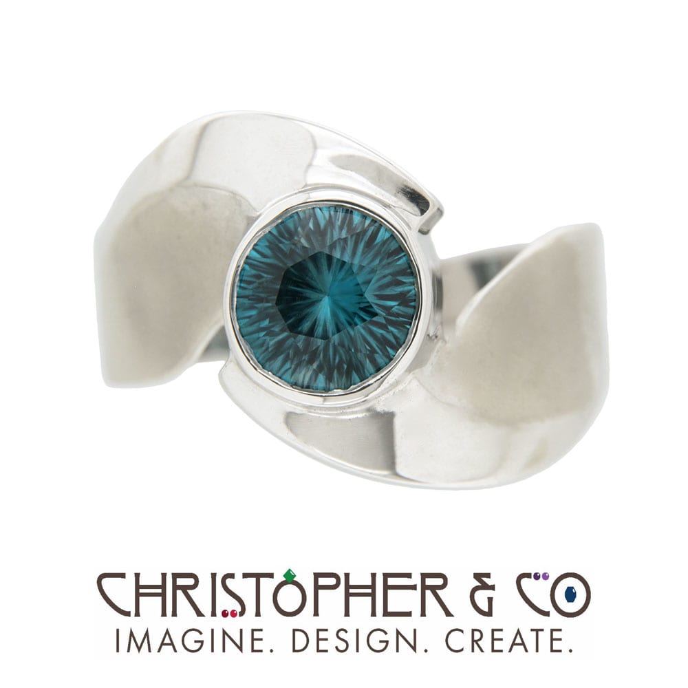 CMJ W 21001  White Gold ring set with concave cut Blue Zircon handcut by Richard Homer and designed by Christopher M. Jupp.  Image: CMJ W 21001  White Gold ring set with concave cut Blue Zircon handcut by Richard Homer and designed by Christopher M. Jupp.