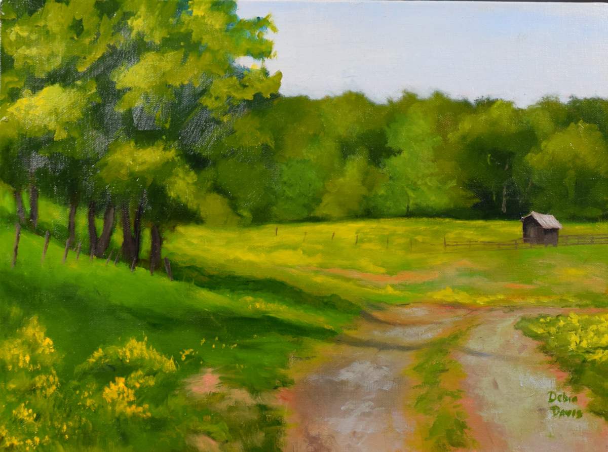 The Turning Path by Debra Davis  Image: There’s a moment when the road curves and everything softens — the light, the wind, the rush of the day. “The Turning Path” is a quiet pause in oil, capturing the hush of the Southern countryside just before summer blooms into full song. For those who long for slower days and golden light.