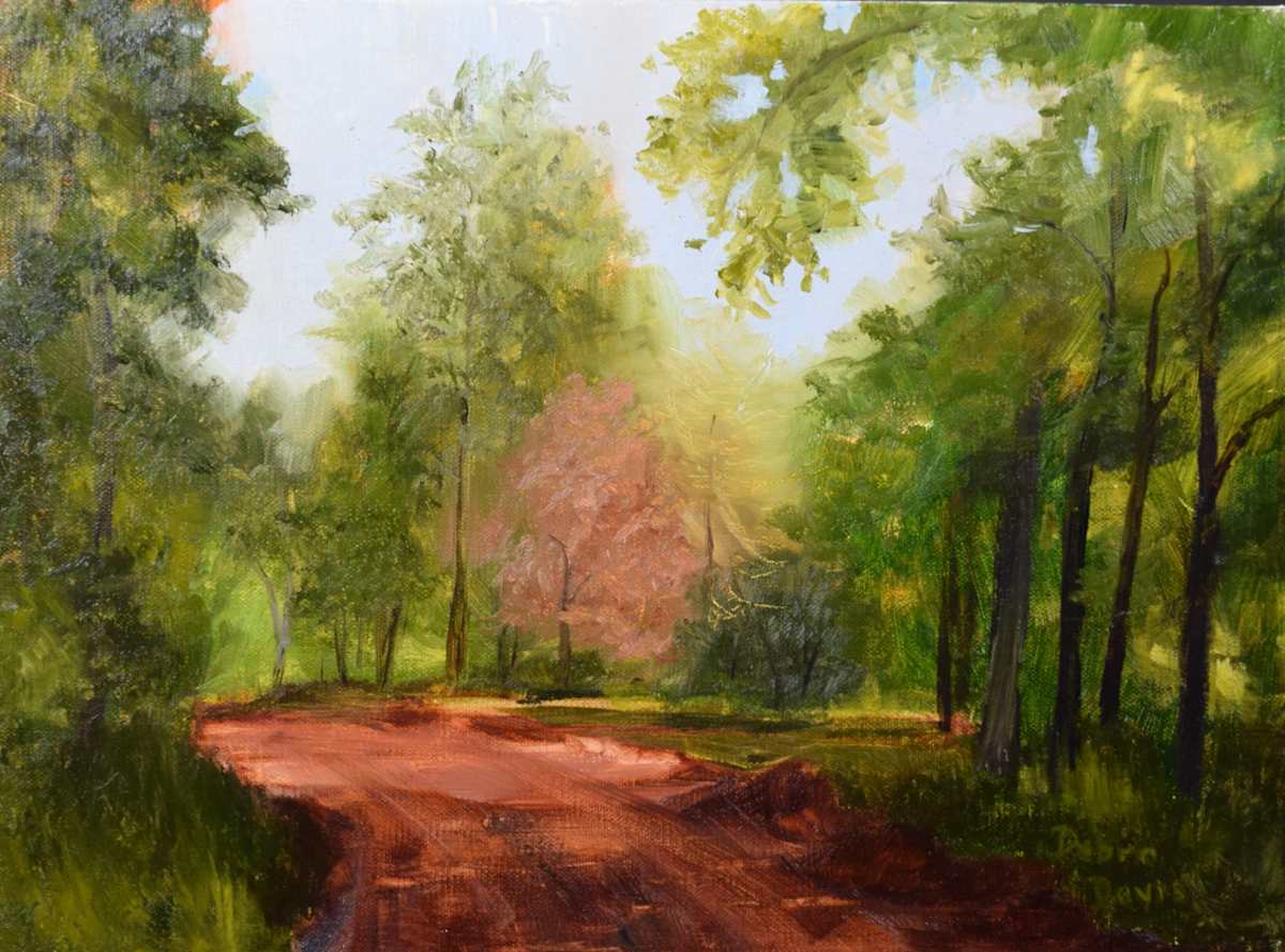 Sunlight's Embrace by Debra Davis  Image: A red clay path, soft green trees, and gentle morning light—this oil painting captures a quiet moment of Southern peace. 