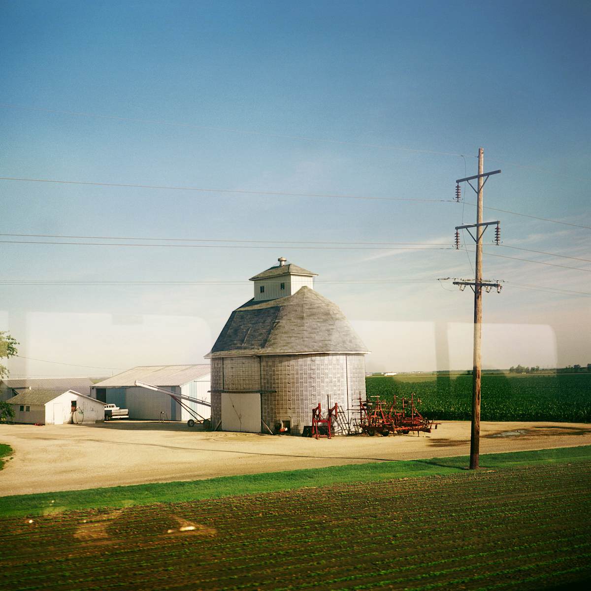 From An Amtrak Train, Majestic Farm Building, Il, 1996 by Alen MacWeeney 