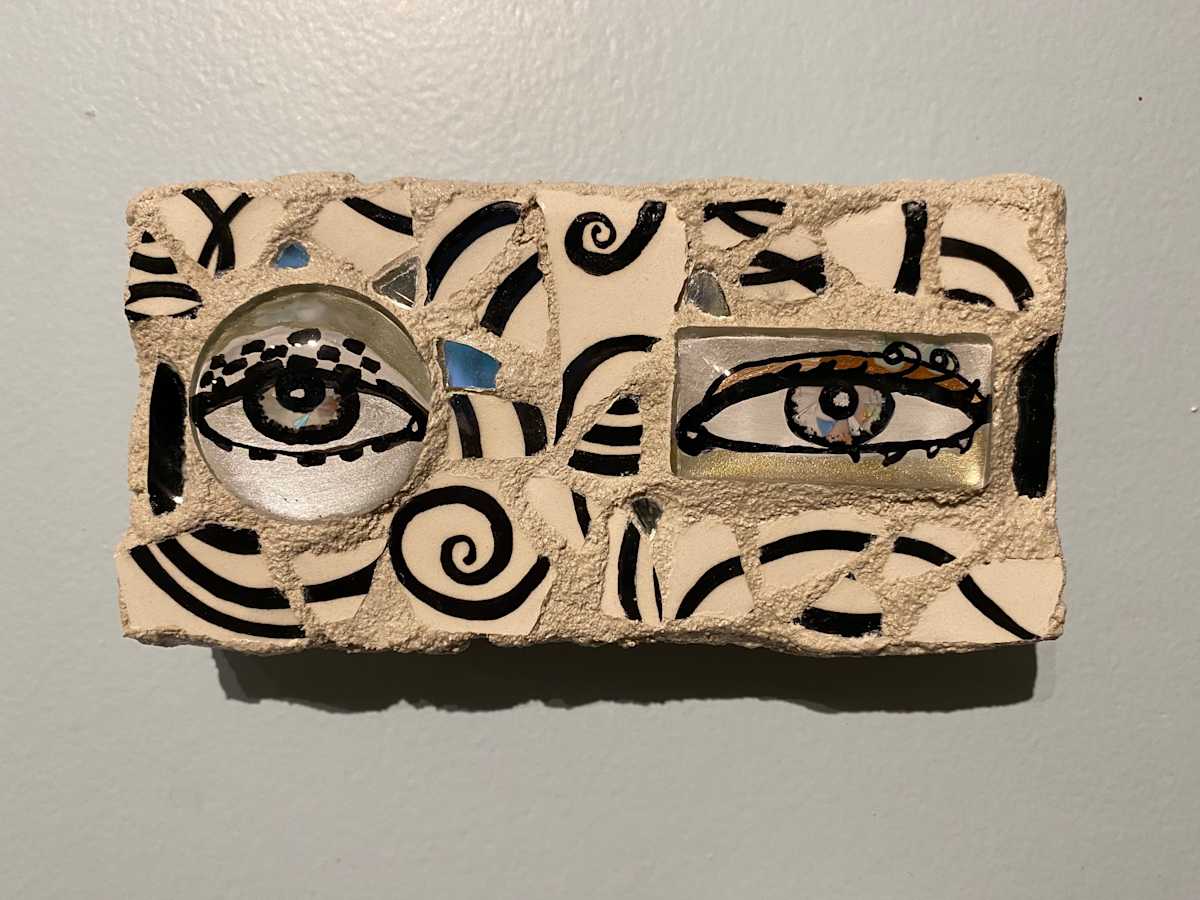 Reflector XXVII (Eye Mosaic #27) by Lisa Shinault  Image: A pair of unmatched eyes made to hang on a wall to 'keep and eye on things'.  This is number 27 of LiShinault Reflector Eye Mosaic series on stone tile. 
