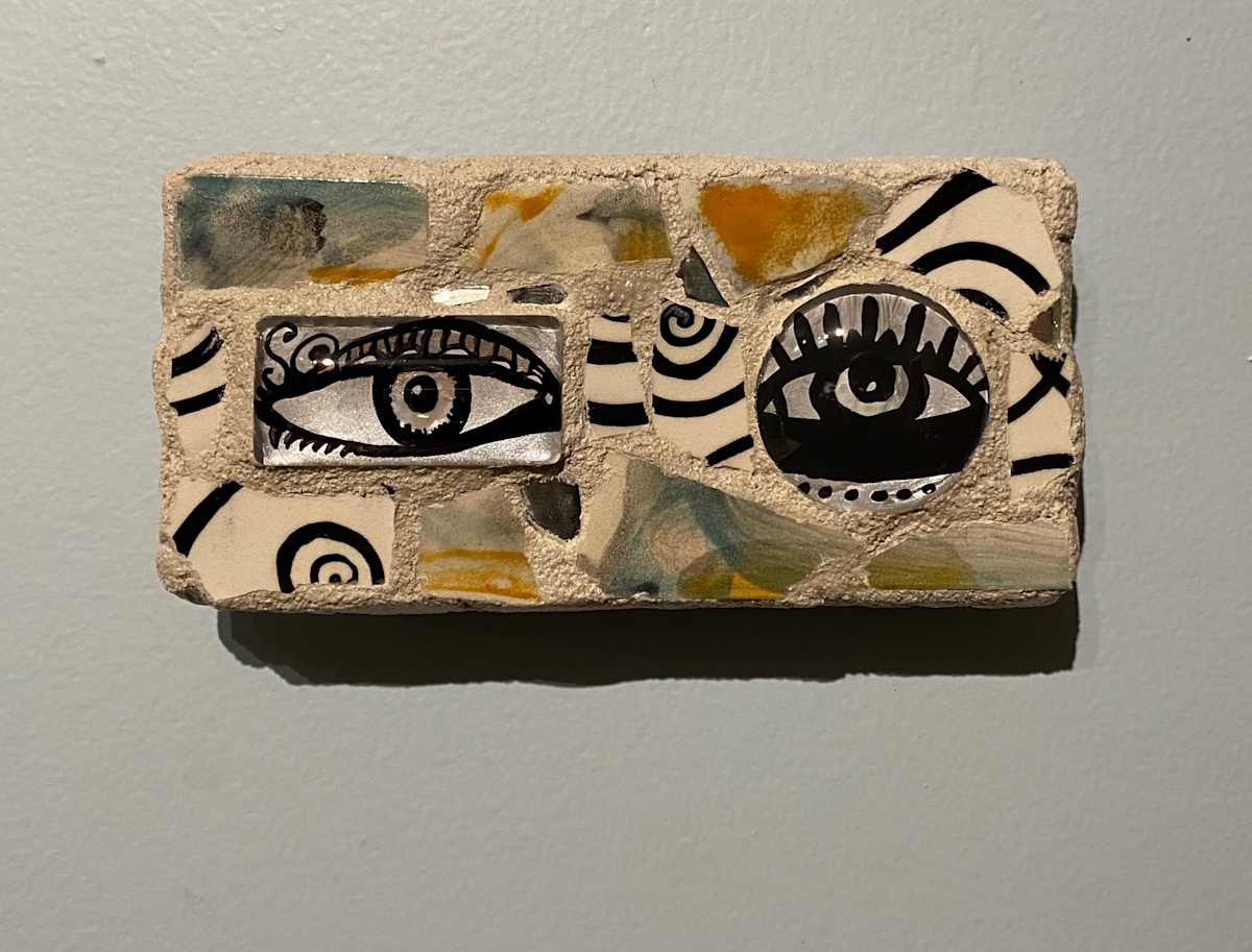 Reflector XXIX (Eye Mosaic #29) by Lisa Shinault  Image: A pair of unmatched eyes made to hang on a wall to 'keep and eye on things'.  This is number 29 of LiShinault Reflector Eye Mosaic series on stone tile. 
