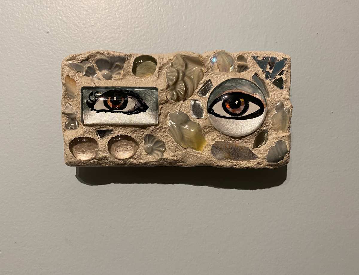 Reflector XXVIII (Eye Mosaic #28) by Lisa Shinault  Image: A pair of unmatched eyes made to hang on a wall to 'keep and eye on things'.  This is number 28 of LiShinault Reflector Eye Mosaic series on stone tile. 
