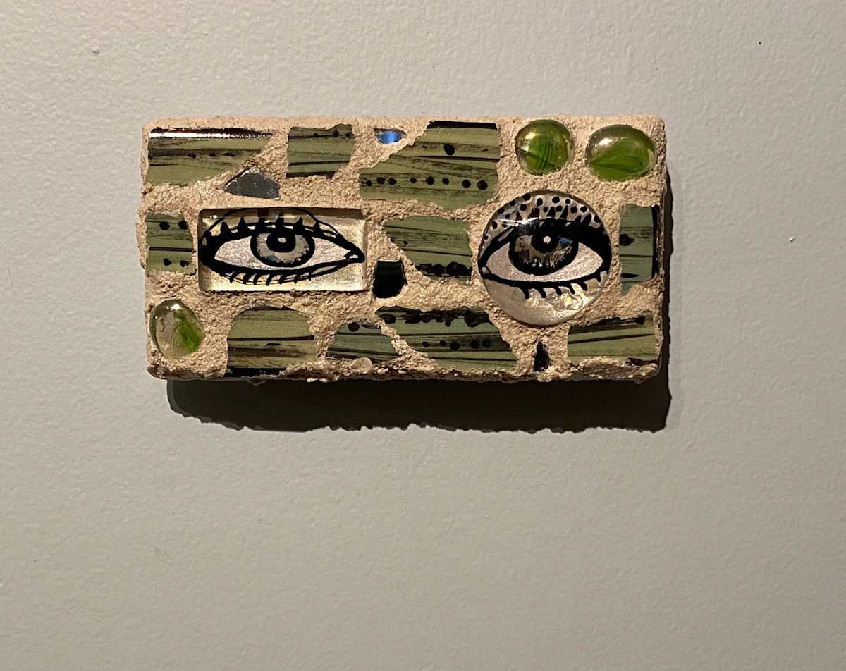 Reflector XXV (Eye Mosaic #25) by Lisa Shinault  Image: A pair of unmatched eyes made to hang on a wall to 'keep and eye on things'.  This is number 25 of LiShinault Reflector Eye Mosaic series on stone tile. 
