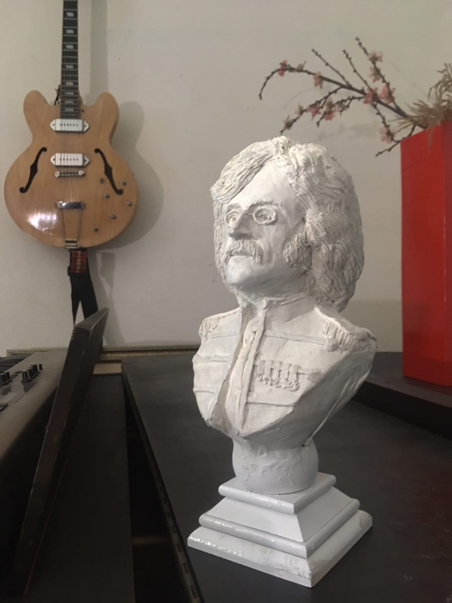 Lennon composer bust sculpture by Dan Terry  Image: This is the original clay sculpture of John Lennon created by Dan which rests proudly on his Hammond B3 organ in his studio. Inspired by the composer busts of classical composers like Bach and Mozart, Dan thought it only fitting and proper for Lennon to have a similar one in his image. While the original master sculpture is not for sale, a few Limited edition casts in Marble Resin have been commissioned through direct request. Price of each is set at $2000. The bust stands 12" tall and 6" wide. 