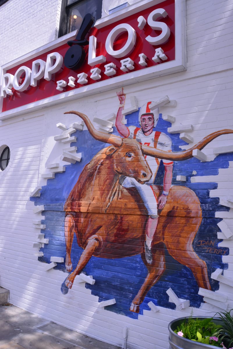 Roppolos_Bevo-Breakthrough mural by Dan Terry  Image: Calling all UT fans is this breakout exterior mural on Guadalupe St. on the UT campus drag inviting fans, students and faculty to one of the longest running, most popular pizza parlors in Austin. This 3Dimensional work is about 12' x 12' wide. 