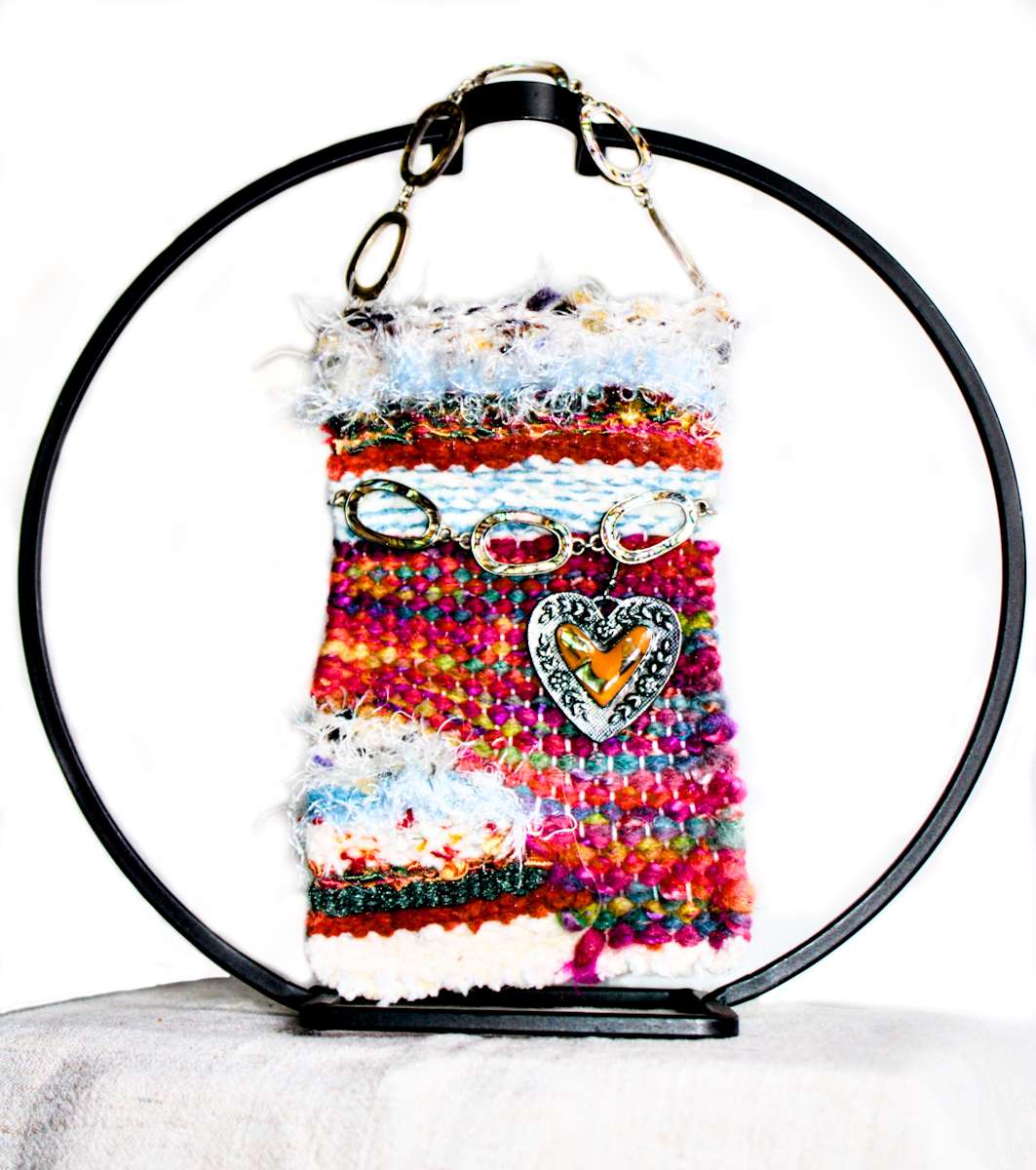 Vibrations of Orange Mini Art Tapestry by Annette  Image: Orange hearts, shell pearled links showcased on a splash of fiber color.  Metal circle ornament holder stand not included in this art piece. 