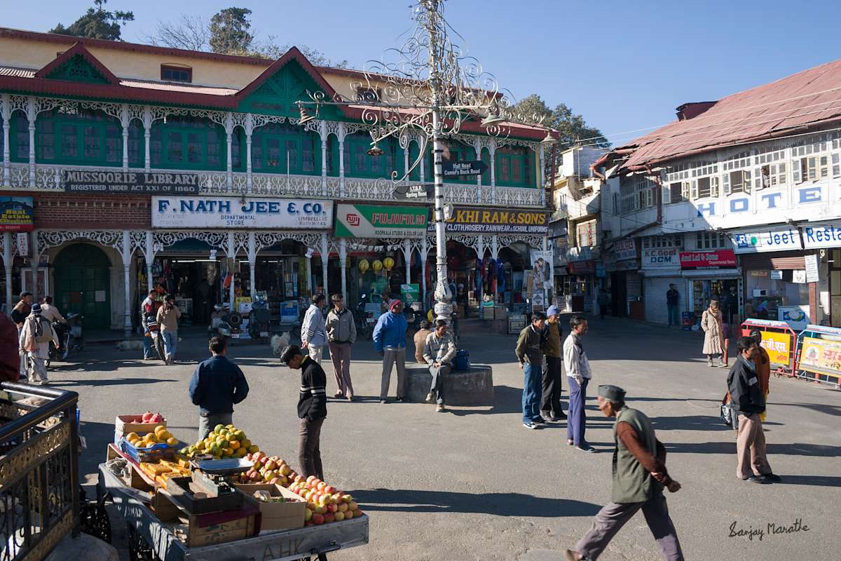 Library Bazaar, Mussoorie (2005) by Sanjay Marathe  Image: A common sight at the market square in front of Mussoorie Library, Uttarakhand, India. Locals and visitors gather here to soak in the morning sun and complete their shopping errands.