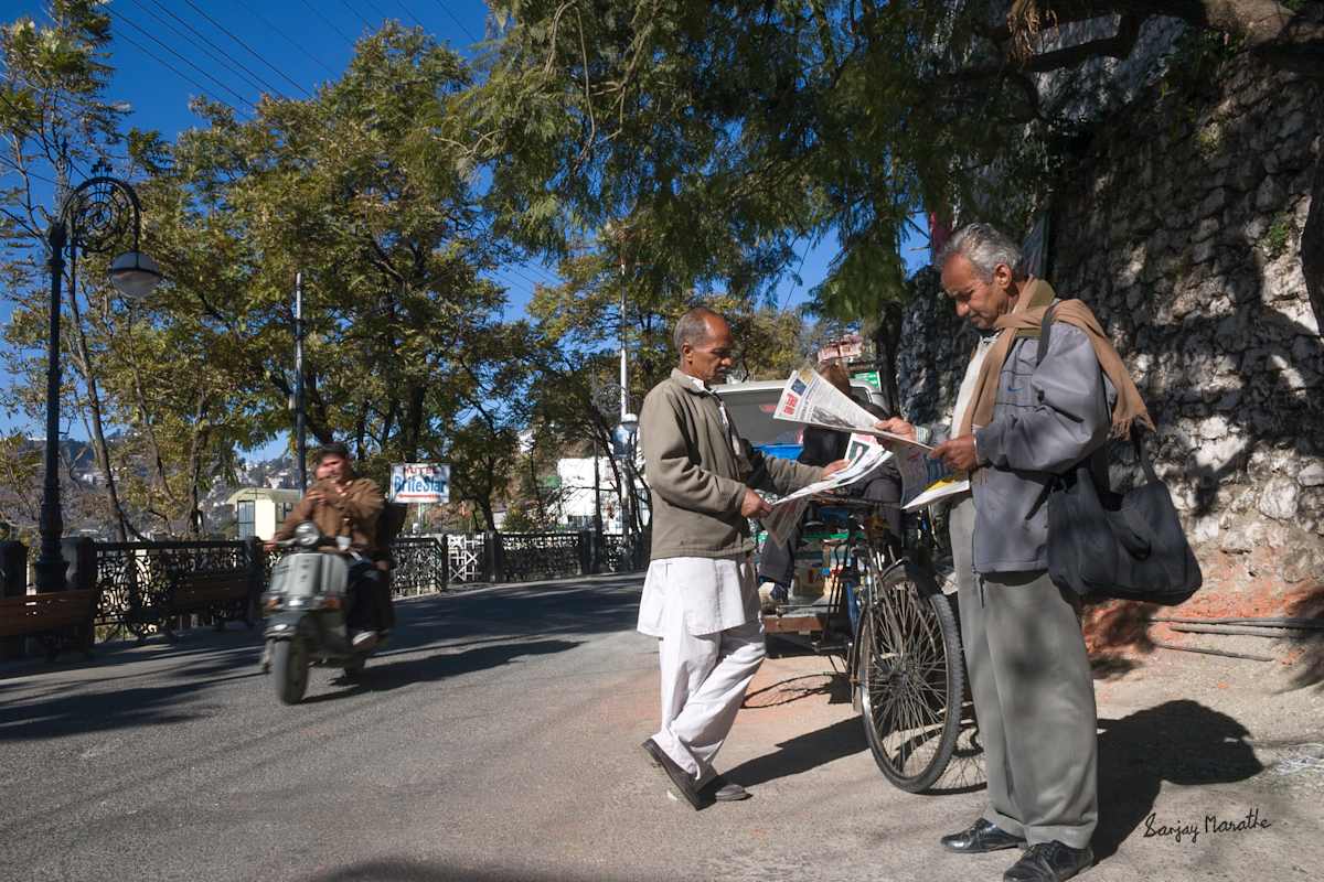 Reading Spot, Mussoorie (2005) by Sanjay Marathe  Image: I took this photograph on a winter morning in Mussoorie, Uttarakhand. The two men stood at a rickshaw stand on the Mall Road, engrossed in their newspaper. Rather than waiting for a ride, they seemed to be simply enjoying a sunny respite from the winter cold.
