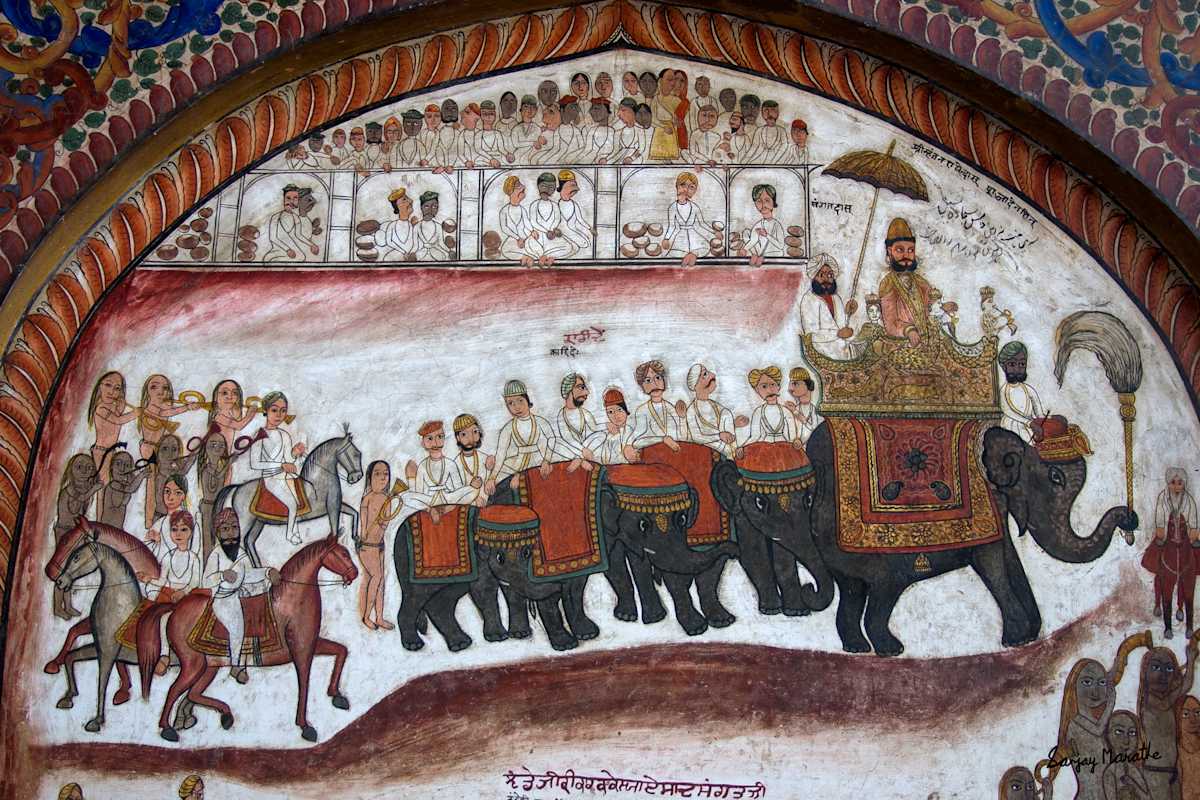 Procession, Mural, Ram Rai Darbar Sahib, Dehradun by Sanjay Marathe  Image: A vibrant mural in the Guru Ram Rai Darbar Sahib in Dehradun, Uttarakhand, India. It showcases exquisite artistry, depicting scenes from mythology, history, and spiritual traditions. These centuries-old paintings, rich in detail and color, adorn the walls of this revered Sikh shrine, offering a glimpse into its cultural and artistic heritage.