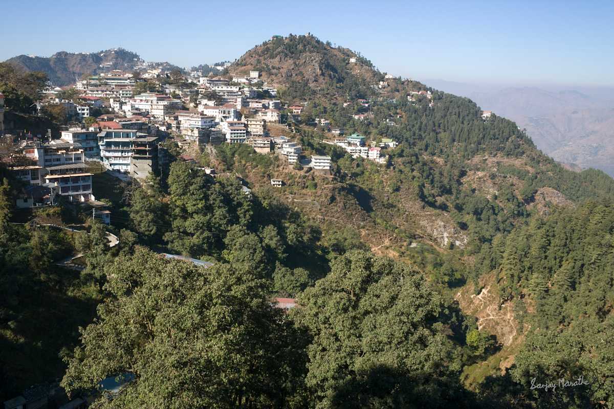 Mussoorie Hills Landscape-1 (2005) by Sanjay Marathe  Image: A view of Mussoorie town nestled among tree-covered hills in Uttarakhand, India.