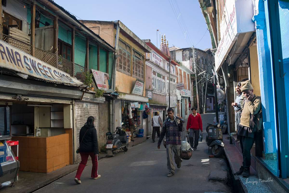 Street In Landour Bazaar, Mussoorie (2005) by Sanjay Marathe  Image: Shops and local businesses line the street in Landour bazaar in Mussoorie, Uttarakhand, India.
