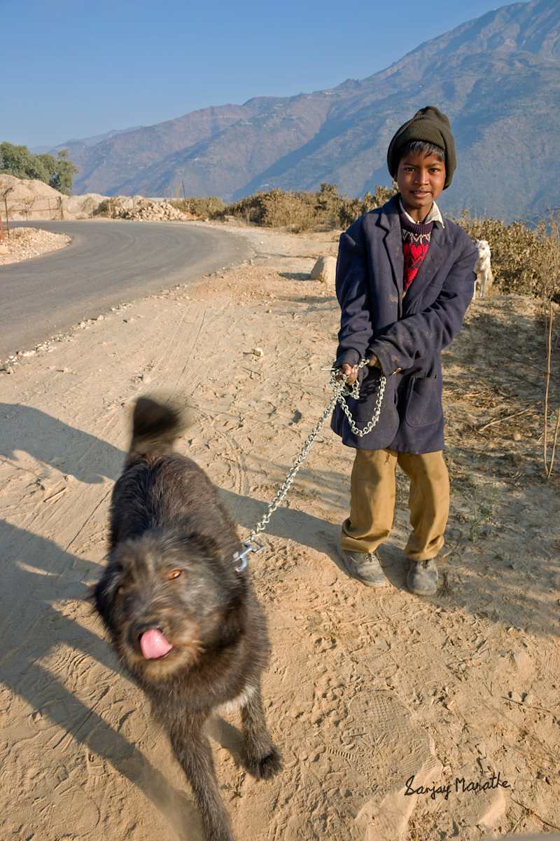 Best Friends-1, Tehri Garhwal (2005) by Sanjay Marathe  Image: A friendly young boy with his black pet dog at a village near Tehri in Uttarakhand state of India.