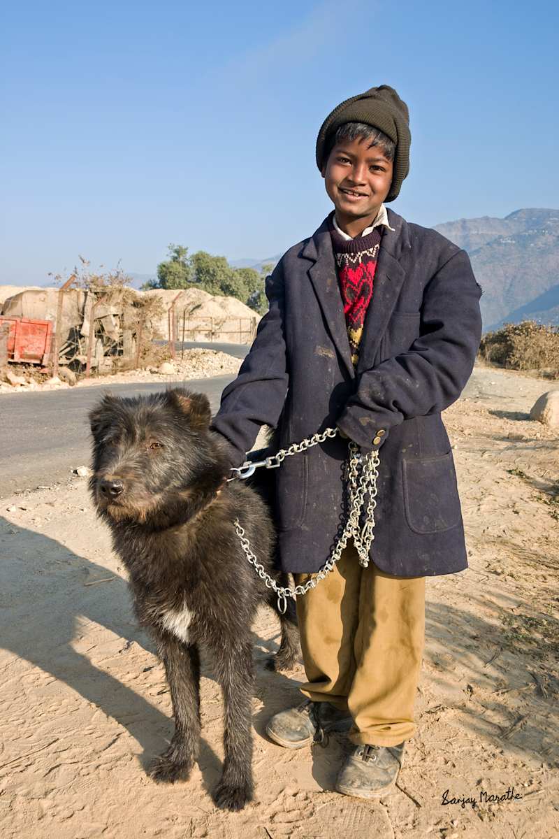 Best Friends-2, Tehri Garhwal (2005) by Sanjay Marathe  Image: A friendly young boy with his black pet dog at a village near Tehri in Uttarakhand state of India.