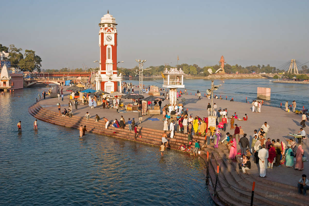 Har-Ki-Pauri-3, Haridwar (2005) by Sanjay Marathe  Image: As the evening sun casts warm light, pilgrims perform ablutions near the Raja Birla tower, also known as the clock tower on the main ghat at the Har-Ki-Pauri at Haridwar, Uttarakhand, India.