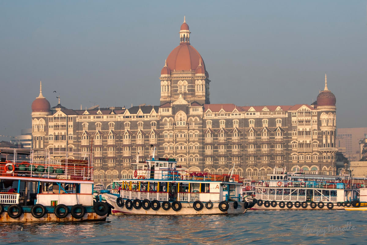Taj Palace Hotel And Ferries, Mumbai (2005) by Sanjay Marathe  Image: The Taj Mahal Palace hotel seen from a ferry near the Gateway of India, Apollo Bandar, Mumbai.