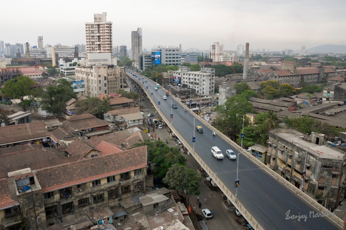 Lower Parel Skyline, Mumbai (2005) by Sanjay Marathe  Image: A modern overpass built along old buildings of the mills era in Lower Parel, Mumbai.
