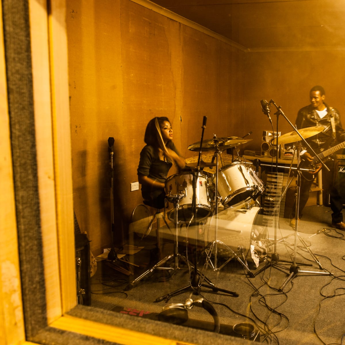 Untitled (Skinflint Rehearsing) by Daniele Tamagni Foundation  Image: Sandra aka. Hurricane Sandy (drummer) and Kebonye Nkoloso (bass player), members of the metal band Skinflint, rehearsing before a concert.