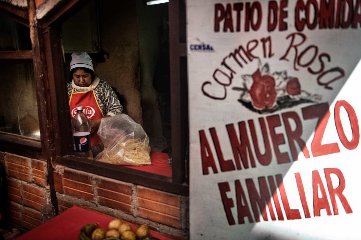 Untitled (Carmen Rosa working at her restaurant)  Image: Carmen Rosa, the founder of the group "Las Diosas del Ring", pioneer and champion of lucha, working in a restaurant snack bar in the city center of La Paz.