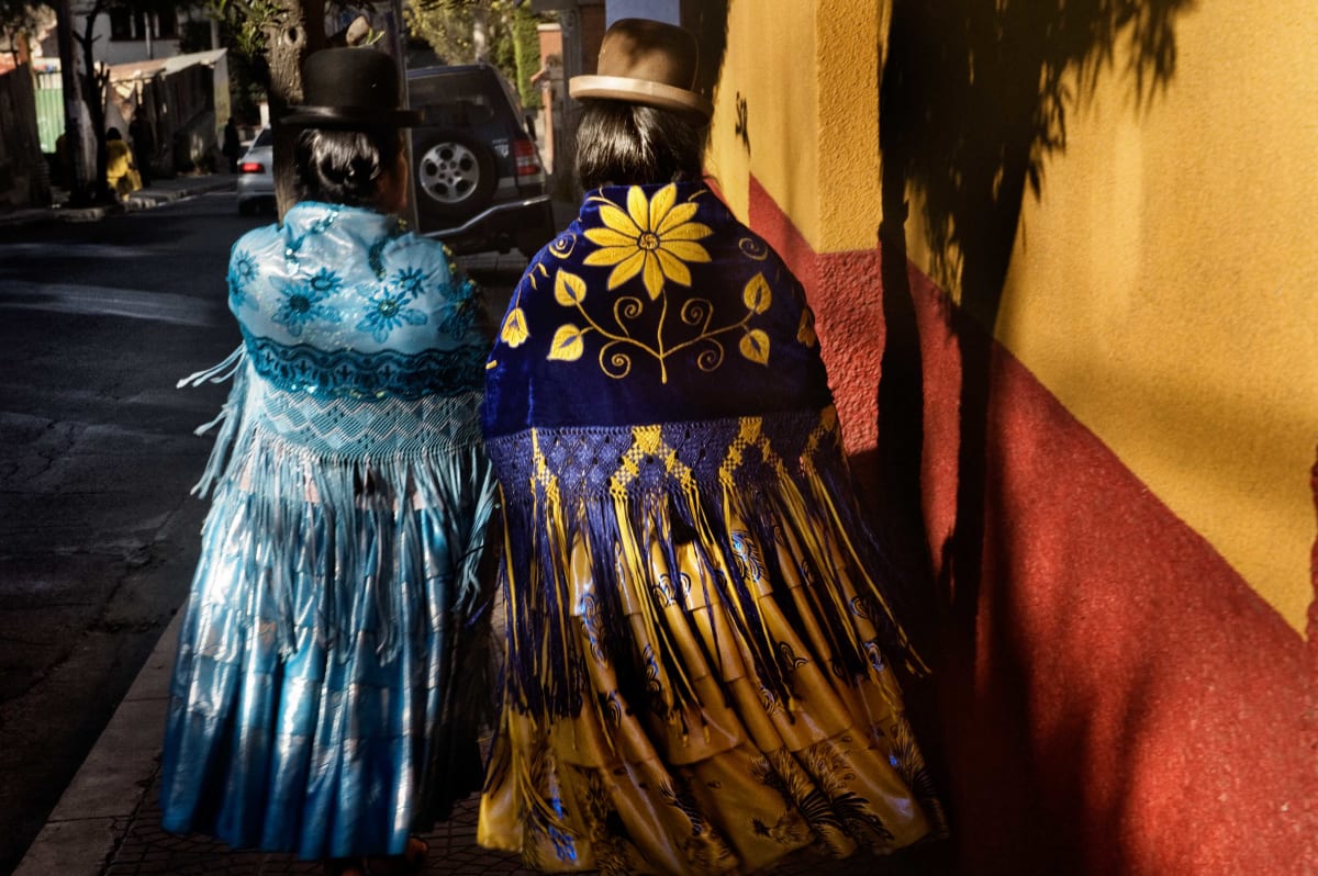 Untitled (Cholitas Walking)  Image: Julia and Carmen Rosa always dress elegantly, as true cholitas do, with their polleras (traditional skirt), bowler hat and embroidered mantle. In the picture, they are strolling through Sopocachi district (La Paz) during a day off.