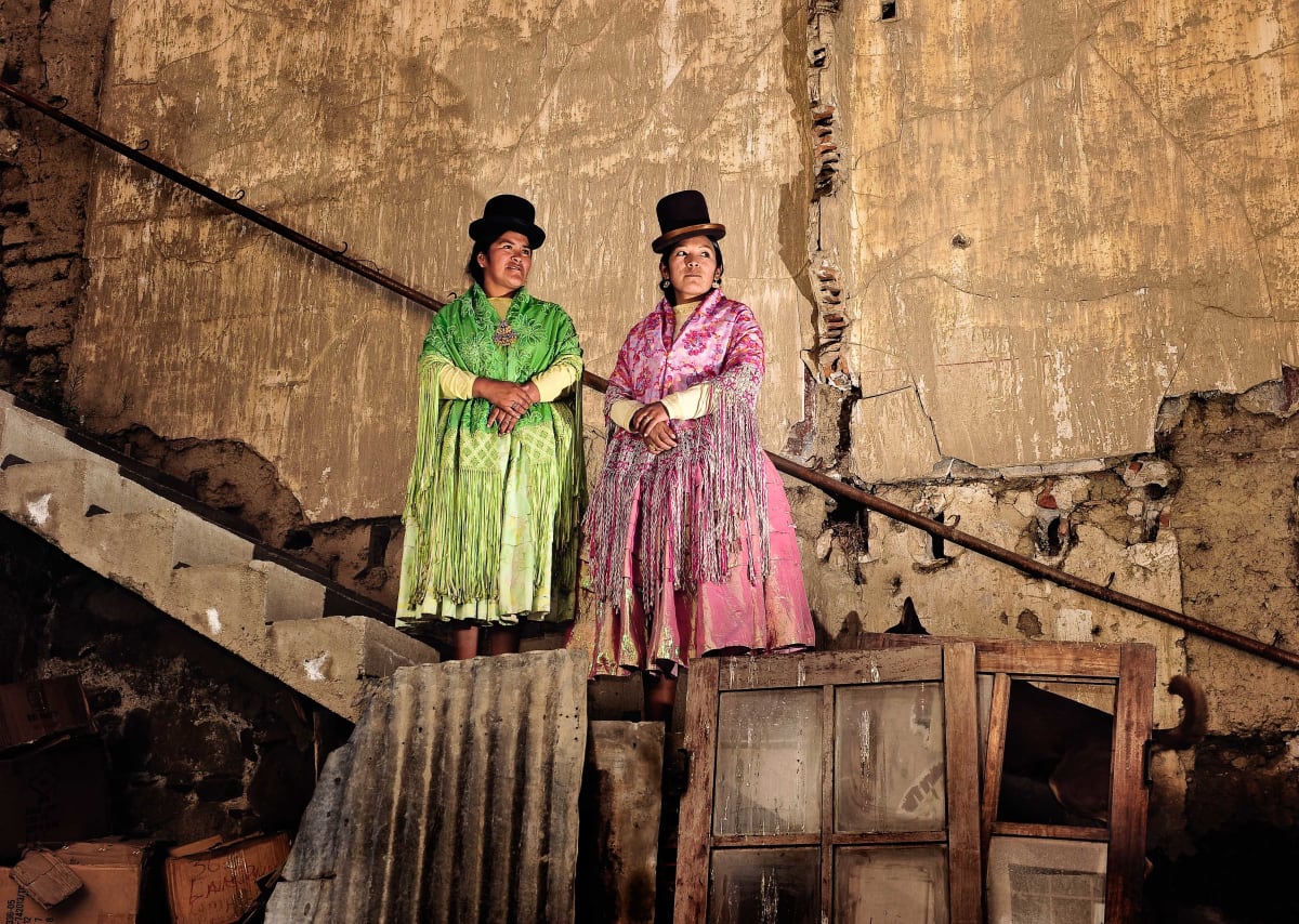 Untitled (Julia and Yolanda)  Image: Julia "La Pacena" and Yolanda "La Amorosa", two fighters of the group "Las Diosas del Ring", in their elegant pastel colored clothes posing on a stairway inside the courtyard where they used to train.