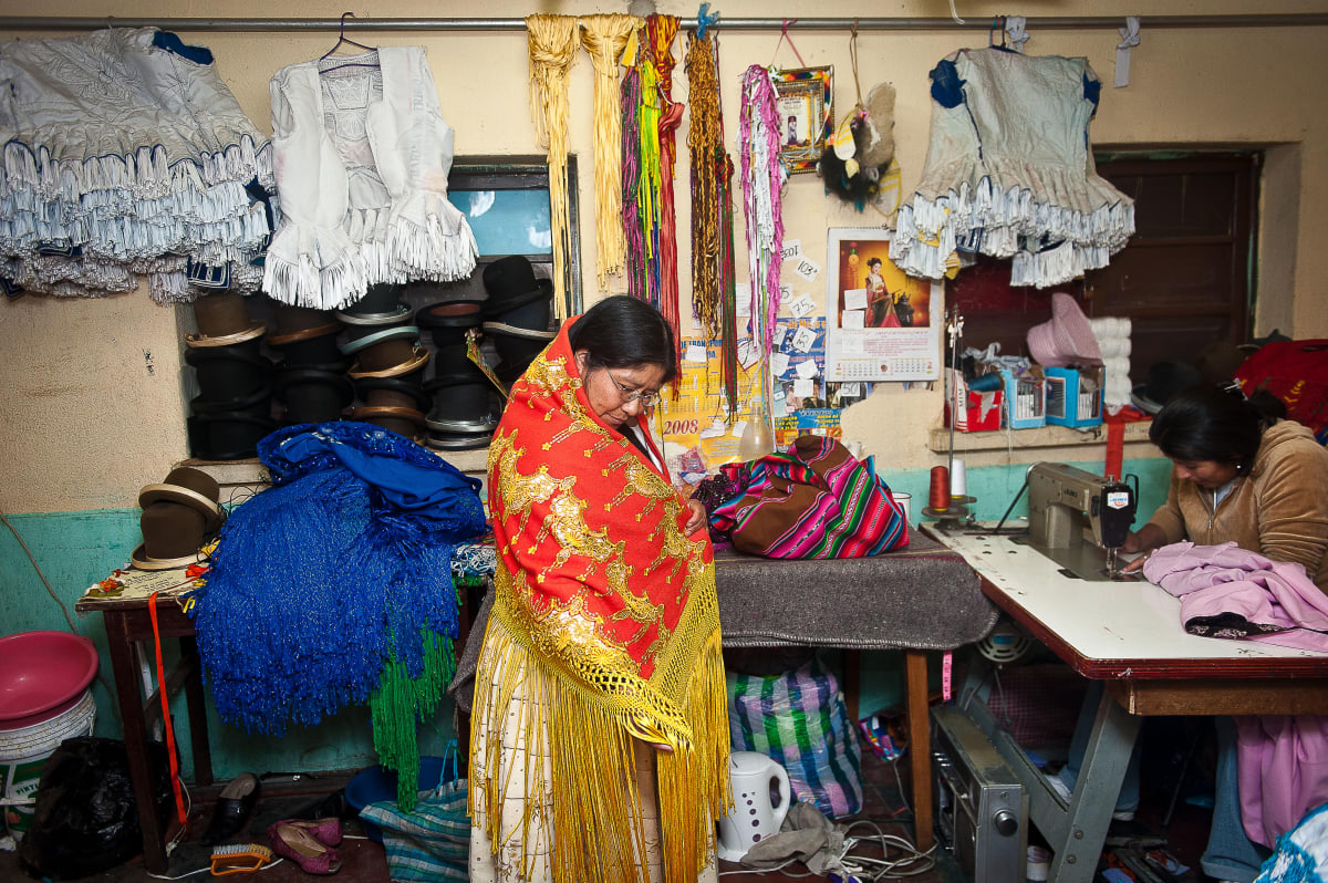 Untitled (Carmen Rosa at the Pollerias)  Image: Carmen Rosa trying on an embroidered mantle in a "Pollerias" shop in La Paz.