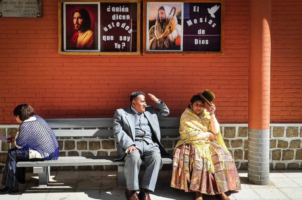 Untitled  Image: Street view of two elegantly dressed man and woman, sitting on a bench.
