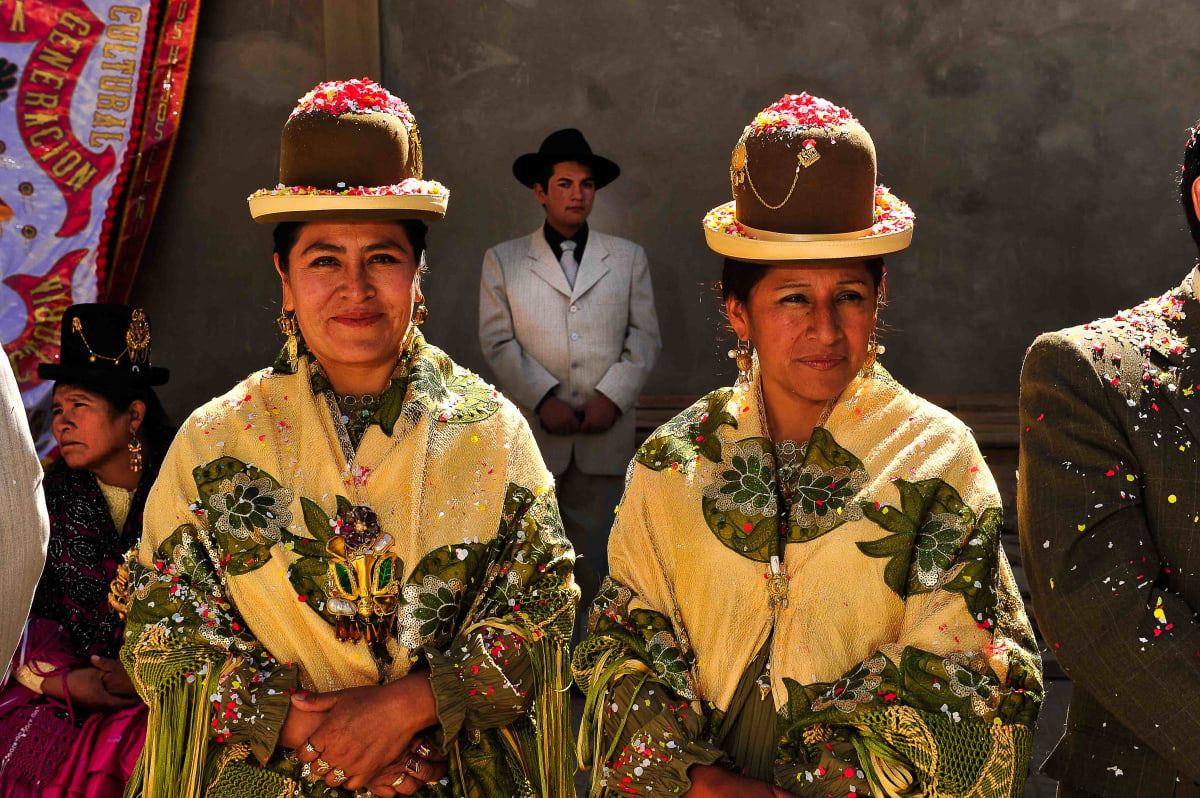 Untitled  Image: Two cholitas with matching outfits looking at the parade of Miss Cholita 2010.