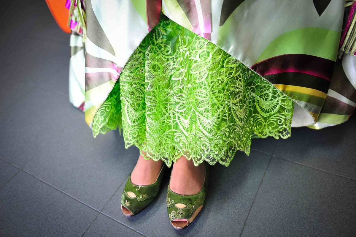Untitled (Cholita's Shoes)  Image: Close up photograph of the laced pollera and green embroidered shoes of a Cholita.