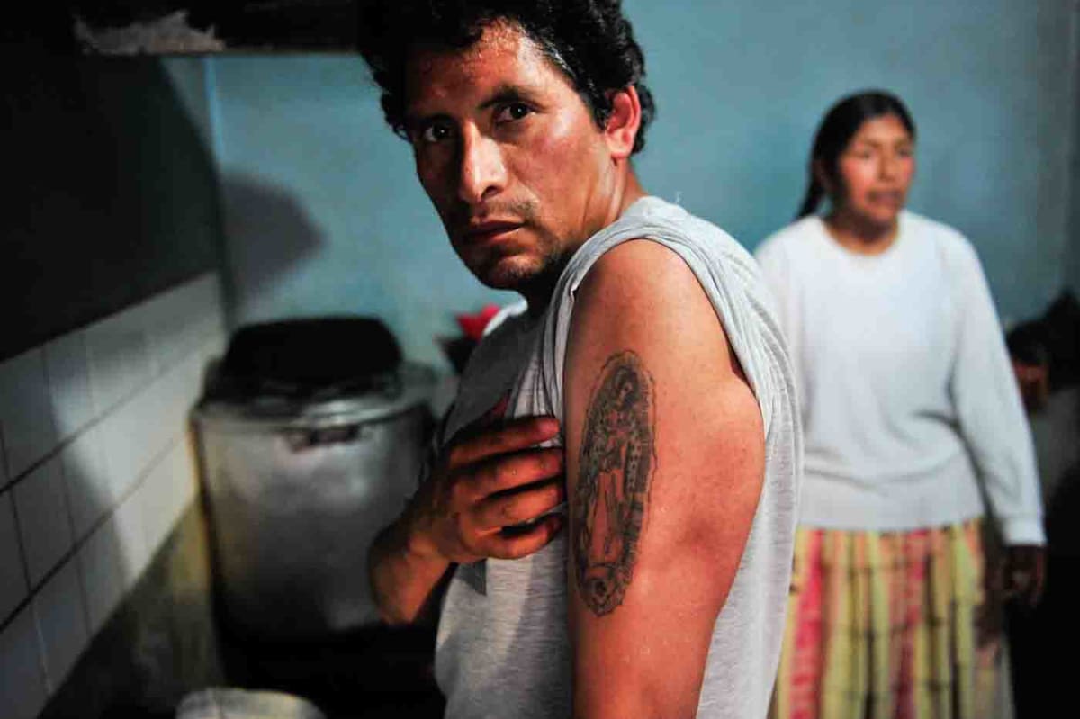 Untitled  Image: A luchador showing his tattoo of the Virgin Mary in the backstage.