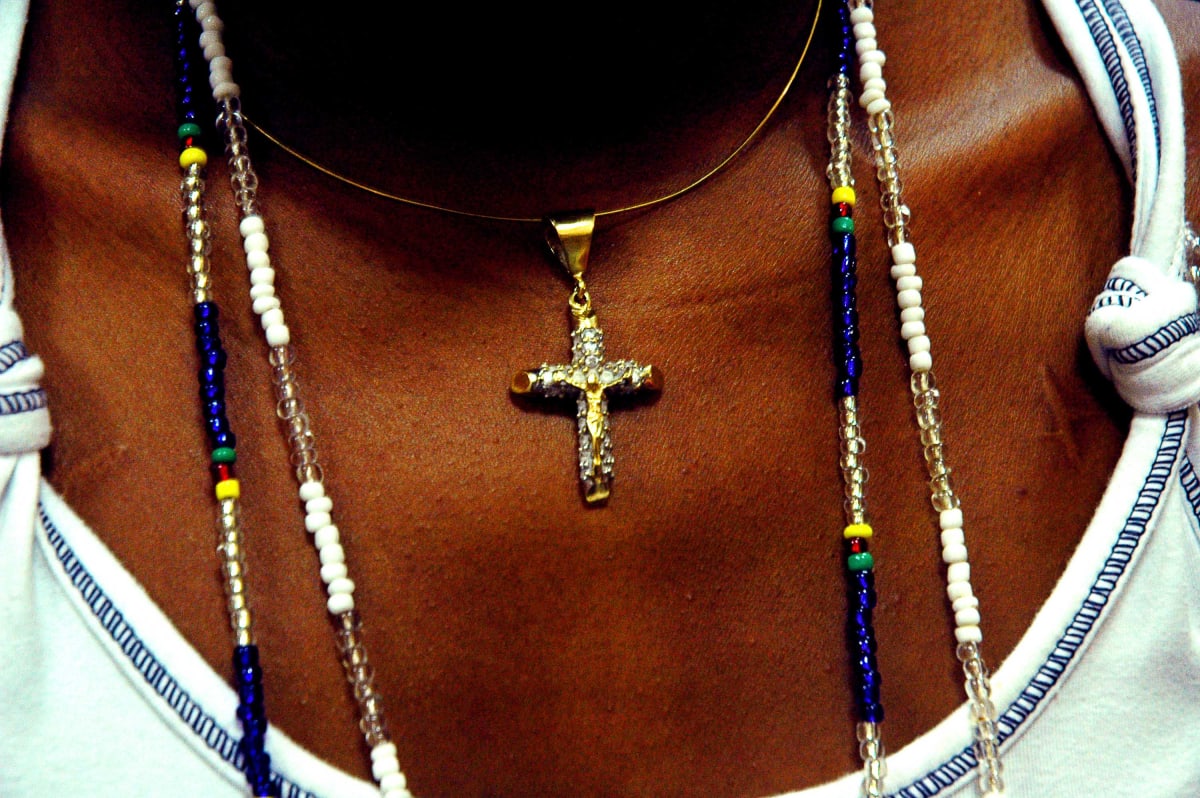 Untitled (Christian Cross)  Image: Close up photograph of a golden Christian cross necklace.