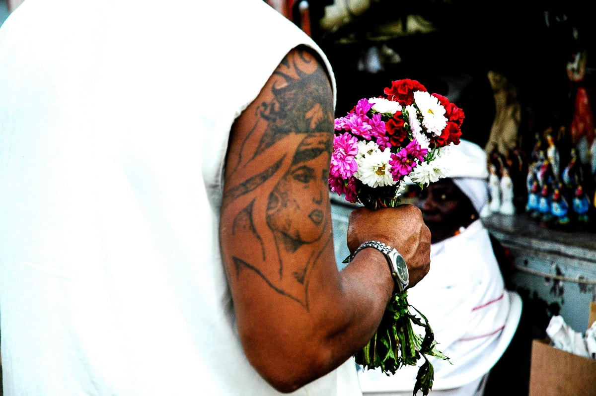 Untitled (Flowers)  Image: A man bringing flowers to a sacred space.