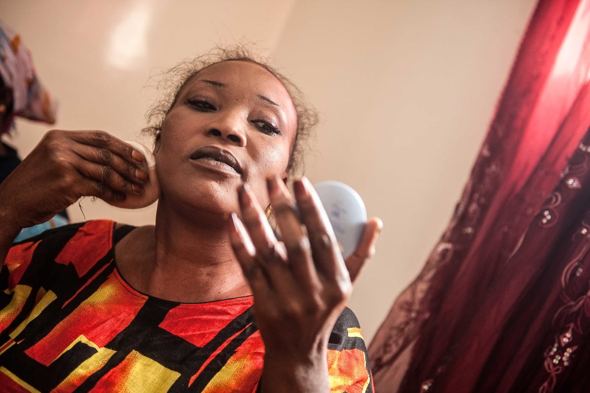 Untitled  Image: Famarama Mbaye applying make-up before going out.