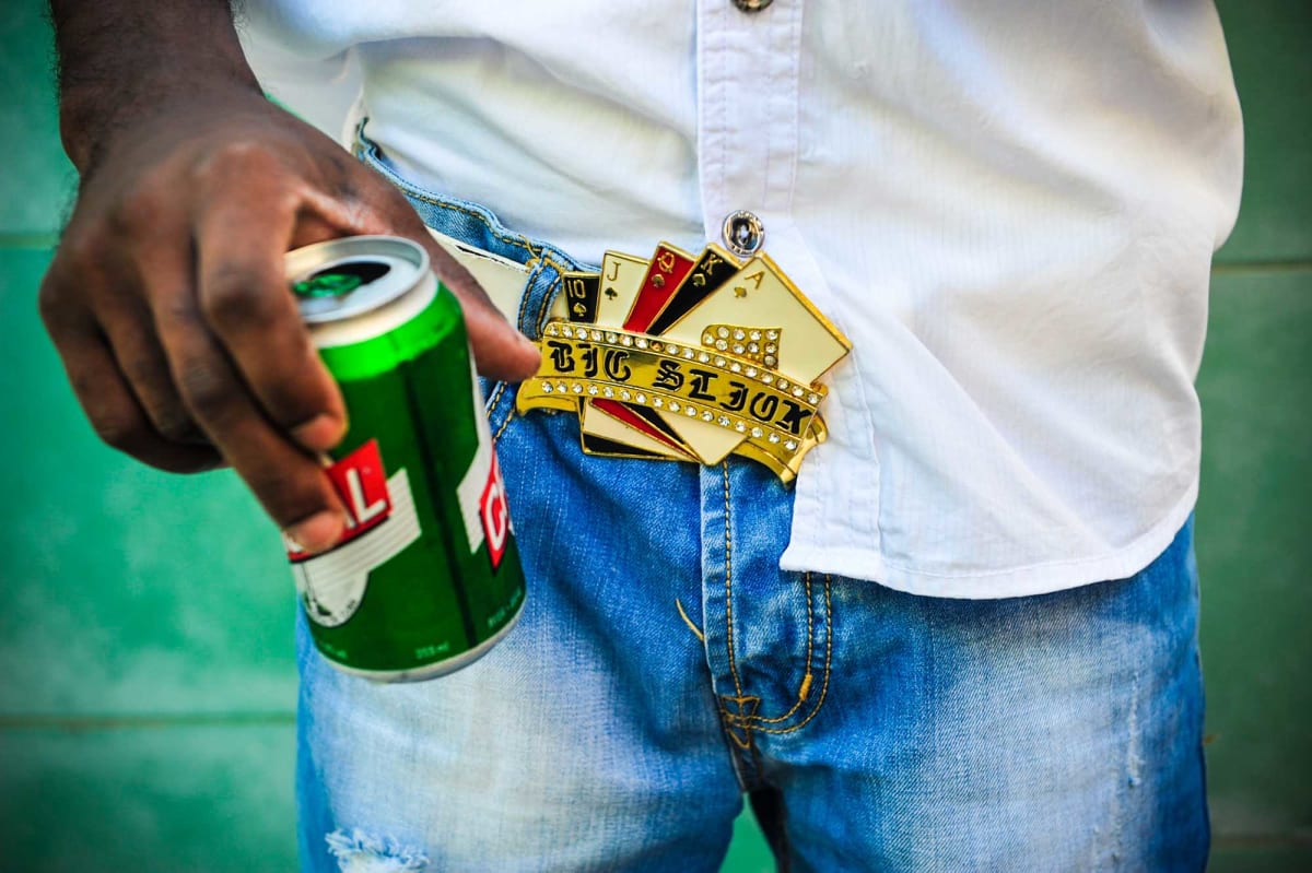 Untitled (Royal Flush)  Image: Close up photograph of a buckle shaped as a royal flush of cards, reading "Big Sljuk(?)"