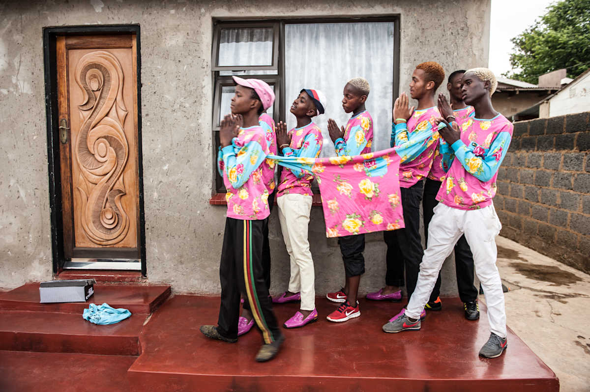 Untitled (Izi's Prayer) by Daniele Tamagni Foundation  Image: A group of young boys of the Izikhothane movement, posing with a stretched t-shirt.