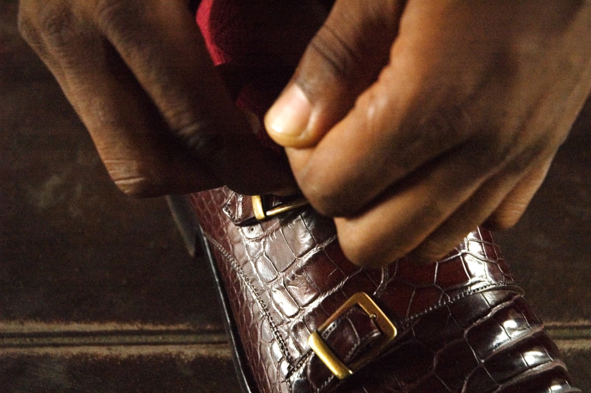 Untitled (Salvador Hassan getting dressed #10)  Image: Salvador Hassan fastening his brown leather shoelaces. Brazzaville, Congo (2007)