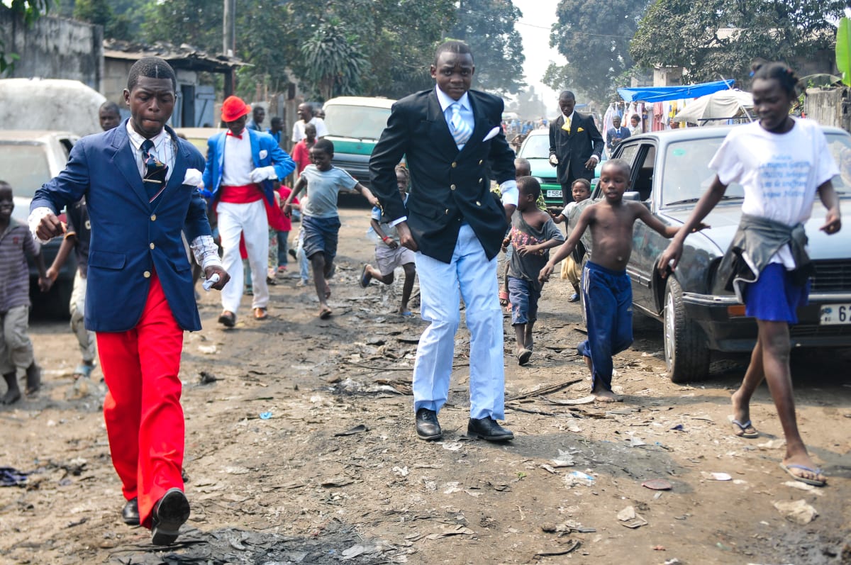 Untitled  Image: Young Sapeurs walking down the street with style, followed by a crowd of kids. Brazzaville, Congo (2008)