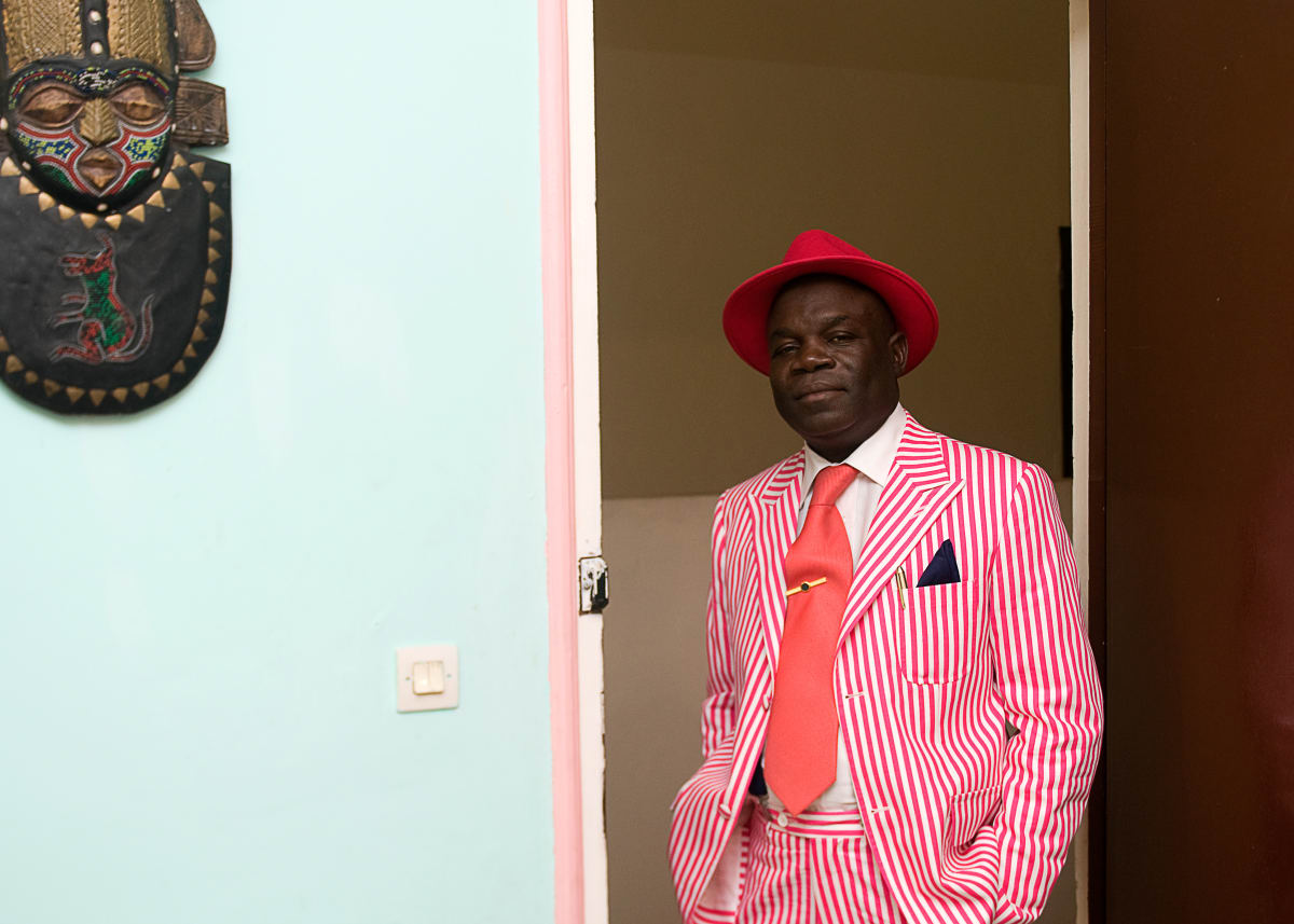 Untitled (The Sapephile Chalereaux Abbot)  Image: Anselme Badiamo, known by all as the 'abbé Chalereux', posing in a hot pink and white pinstriped suit with matching pink hat and tie. Brazzaville, Congo (2008)