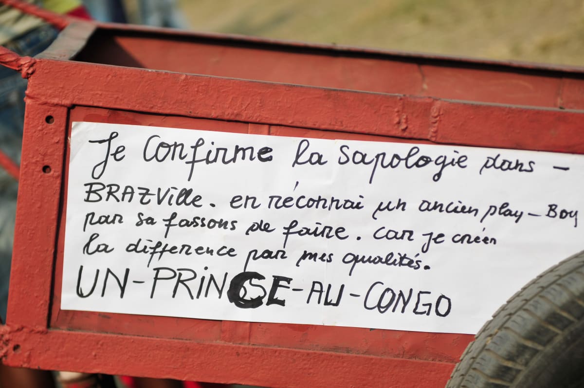 Untitled  Image: Charriot-throne of the 'Prince of Congo', reading: "Je confirme la sapologie dans Brazville, en réconnai un ancien play-boy par sa fassons de faire. Car je créen la difference pas mes qualités. Un-Prince-Au-Congo." (I confirm the Sapology in Brazzaville by recognizing an ancient playboy by his way of doing things. Because I create the difference by my qualities. A Prince of Congo.) Brazzaville, Congo (2008)