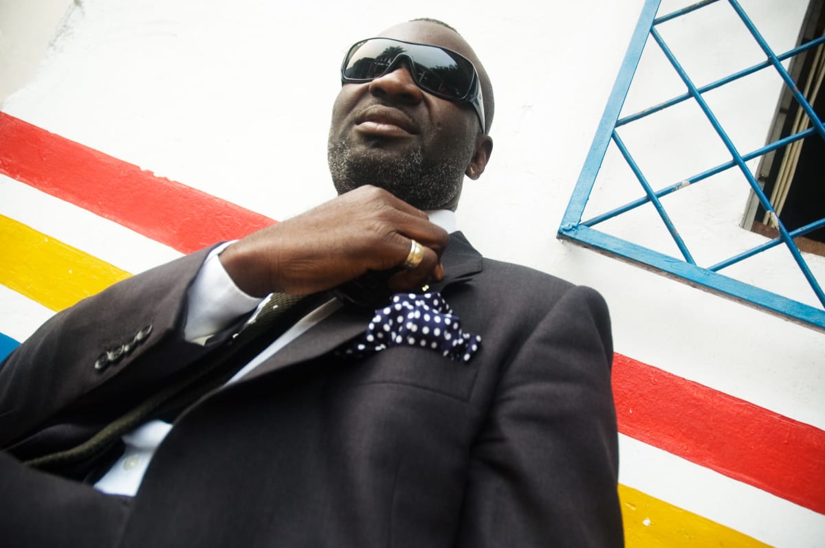 Untitled  Image: Portrait of a man wearing a black suit with blue and white polkadot pocket handkerchief. Brazzaville, Congo (2007)