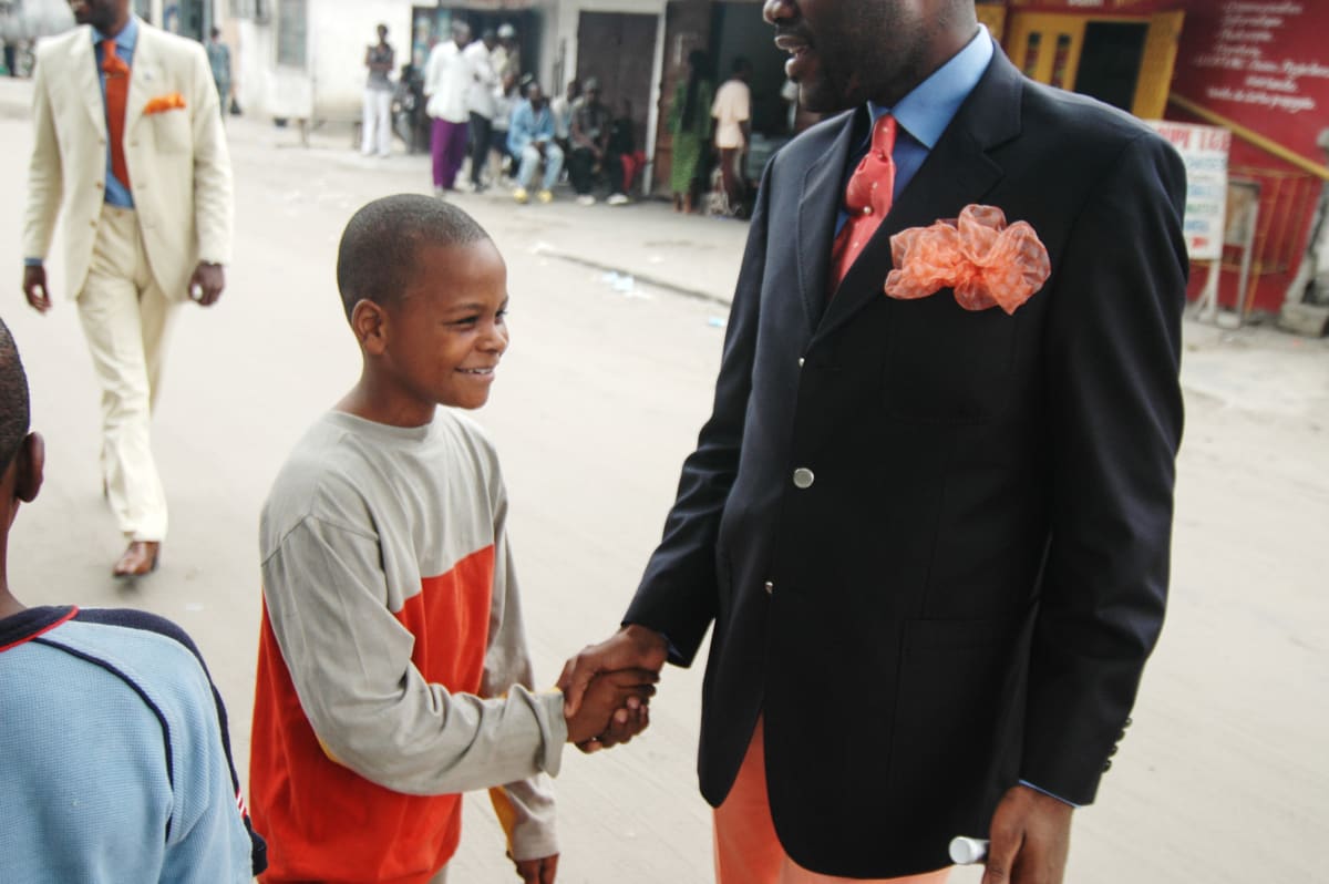 Untitled  Image: Salvador Hassan shaking hands with a kid in the Poto Poto district of Bazzaville, Congo. (2007)