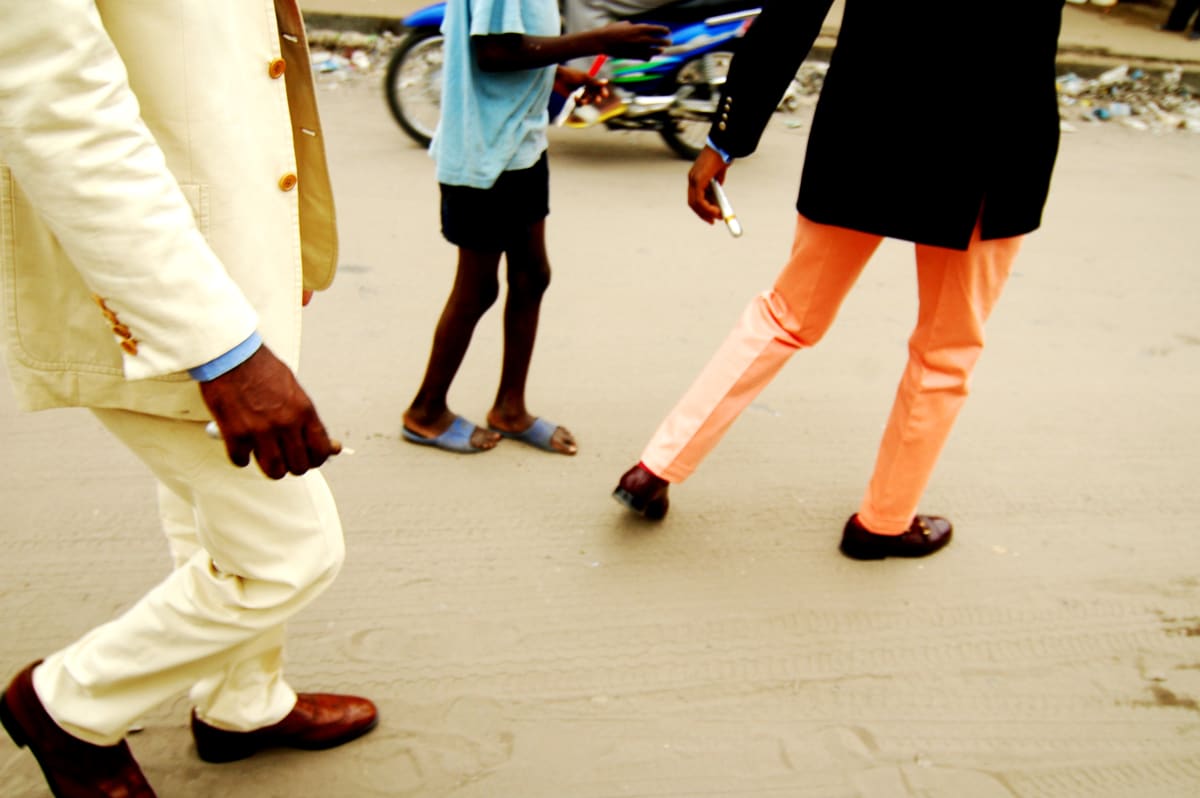Untitled by Daniele Tamagni Foundation  Image: Savador Hassan and his friend Phael walking through the district of Poto Poto, Brazzaville, Congo (2007).