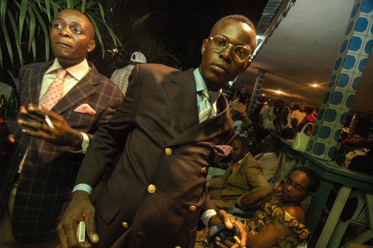 Untitled  Image: Sapeur with black suit, light blue shirt and golden spectacles at the Main Bleu club. Brazzaville, Congo (2007)