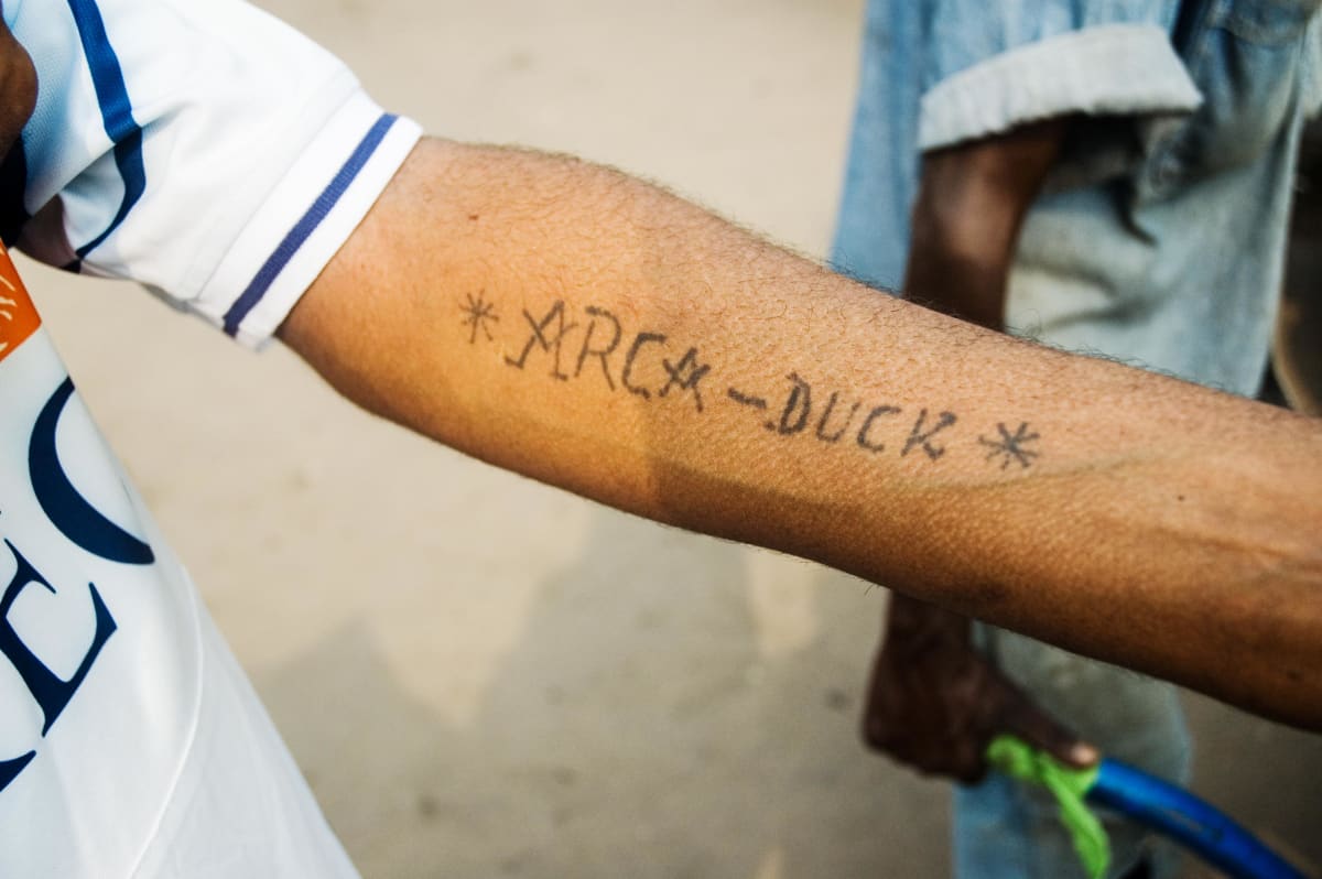 Untitled (Arca Duck)  Image: Arca showing a tattoo on his forearm reading 'ARCA-DUCK'. Brazzaville, Congo (2007)
