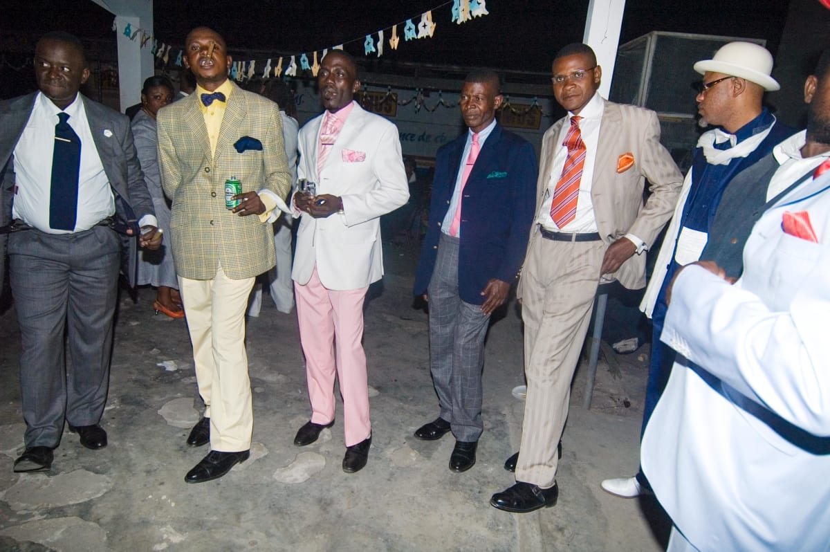 Untitled (Sapeurs a la Main Bleu #2)  Image: Group of Sapeurs at the nightclub Main Bleu, with Lalhande (second from the left) and Kvv Mouzieto (second from the right). Brazzaville, Congo (2007)