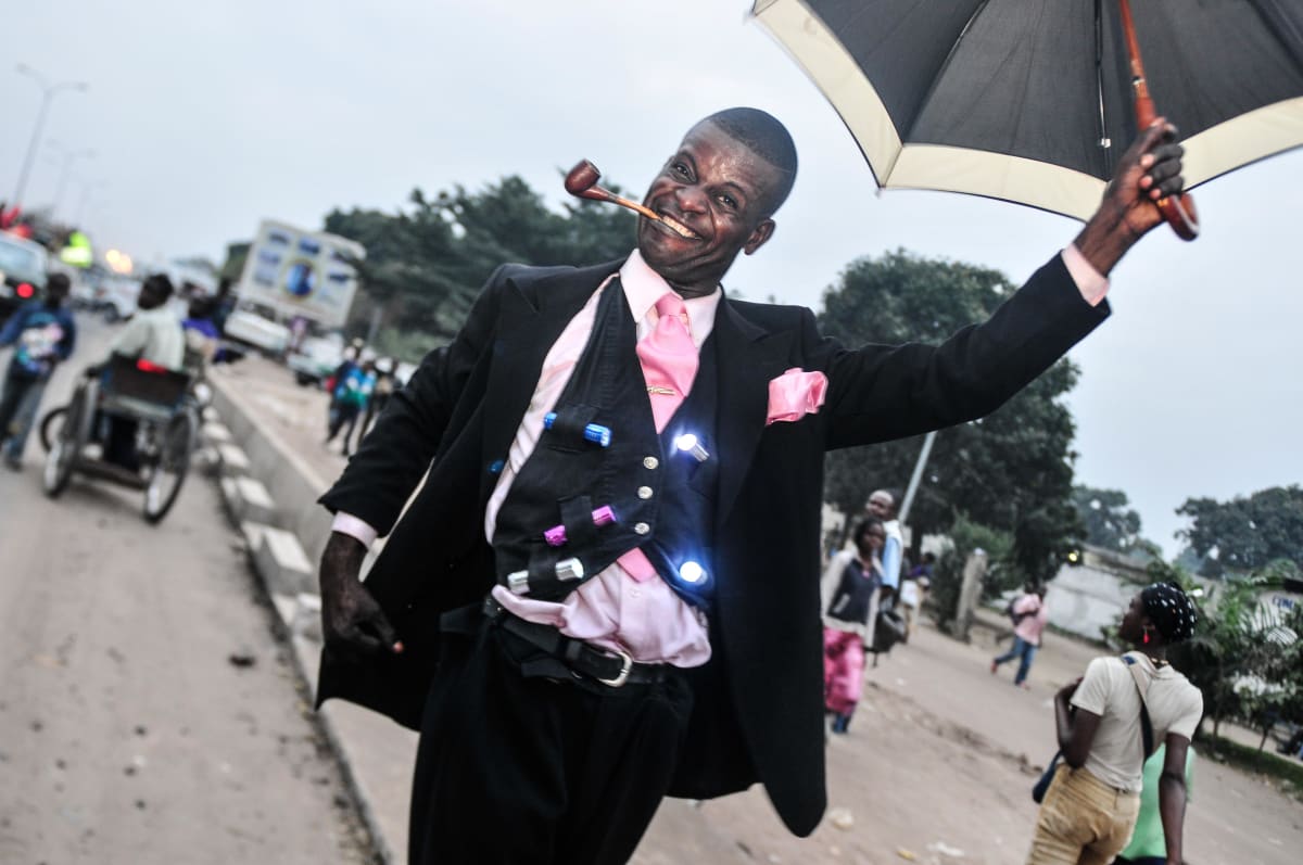Untitled (Christian Malala)  Image: Christian Malala waving his umbrella, flashing the colored torches attached to his waistcoat. Brazzaville, Congo (2008)