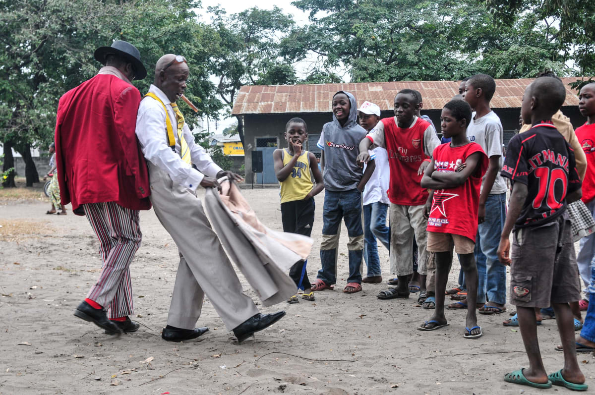 Untitled  Image: Two Sapeurs performing in front of a group of kids. Brazzaville, Congo (2008)